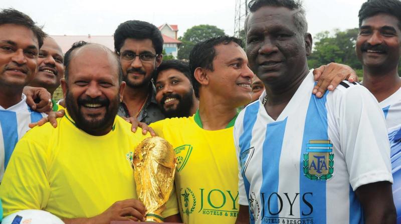 Agriculture Minister V S Sunilkumar presents a replica of FIFA world cup trophy after the exhibition match held in Thrissur on Saturday. Former Indian captain I M Vijayan is also seen.