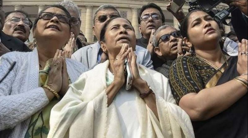 Mamata Banerjee prays in front of the Mahatma Gandhis statue at the Parliament House. (Photo: PTI)