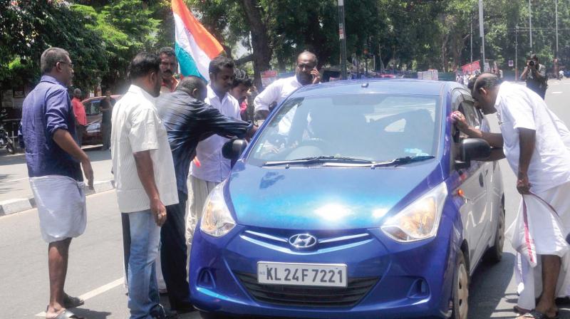 Congress workers block a private vehicle in front the secretariat in  Thiruvananthapuram on Monday.	(Photo: A.V. MUZAFAR)