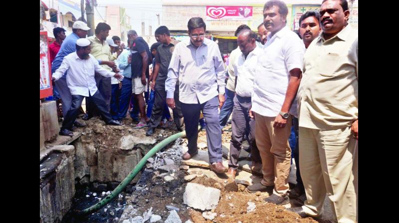 Minister for municipal administration P. Narayana, along with Guntur Municipal commissioner Lathkar Shrikesh Balajirao, inspects works at diarrhoea-affected areas in Anandapet of Guntur city on Monday. (Photo: DC)