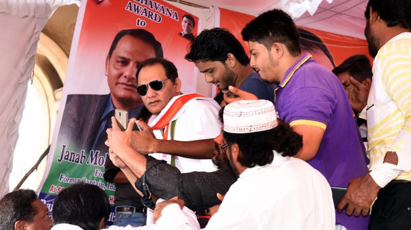 Fans crowd former Team India cricket captain Md Azharuddin for selfies during the Rajiv Sadbhavana Yatra at Charminar on Thursday. 	(Photo: DC)