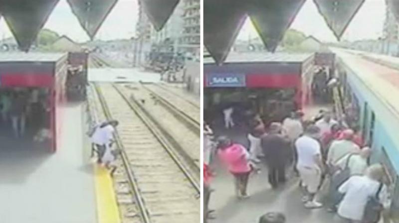 The video footage shows the woman helping her child get down onto the tracks, following which she herself attempts to climb down. (Photo: YouTube Screengrab)