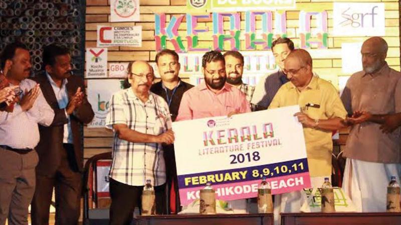 Tourism Minister Kadakampally Surendran launches the logo of 2018 Kerala Literature Fest at the valedictory ceremony at Kozhikode Beach on Sunday. KLF Director K. Satchidanandan, Kozhikode North MLA A. Pradeep Kumar among others look on. (Photo: DC)