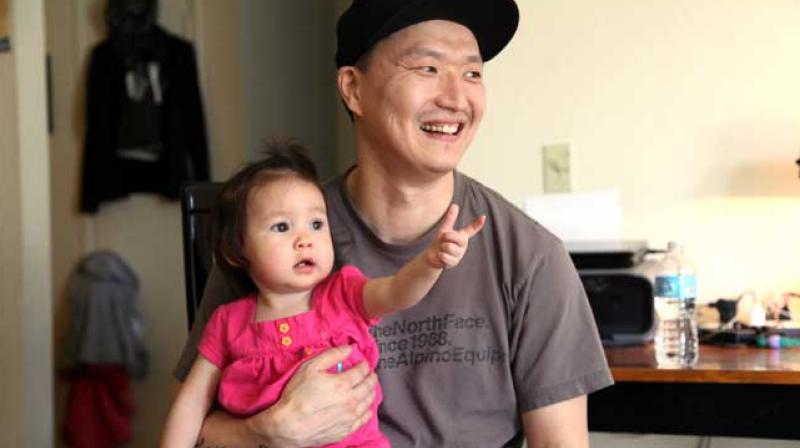 Korean adoptee Adam Crapser poses with daughter, Christal. (Photo: AP)