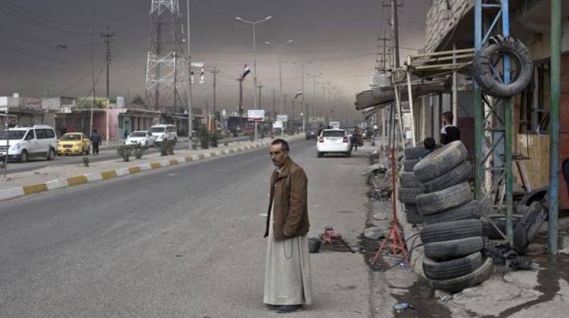 A man stands on a street in Qayyara, some 50 kilometers south of Mosul, Iraq. (Photo: AP)