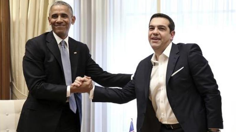 U.S. President Barack Obama, left, shakes hands with the Greek Prime Minister Alexis Tsipras during their meeting at Maximos Mansion in Athens. (Photo: AP)