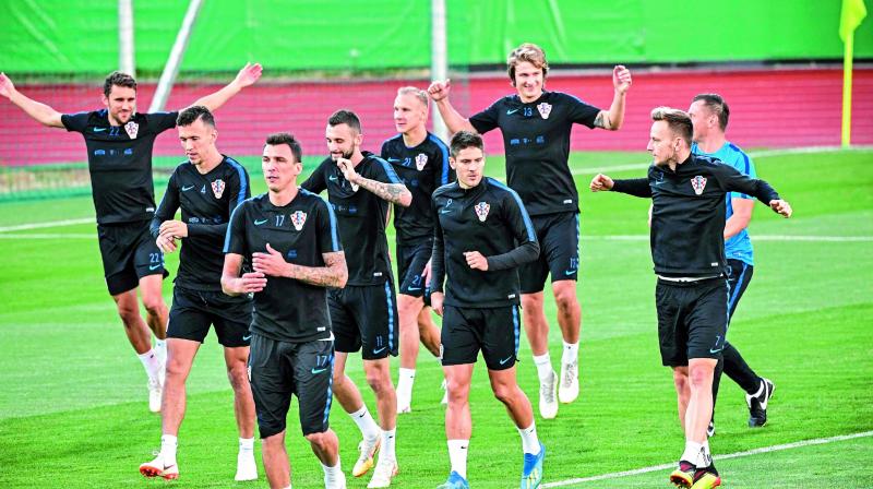 Croatian players flex their muscles as they take part in a practice session at the Luzhniki training field in Moscow ahead of their semifinal match against England. (Photo: AFP)