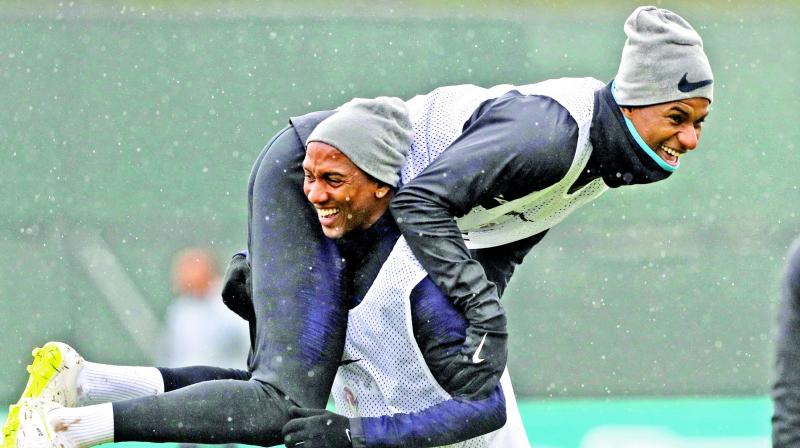 Englands Ashley Young (left) shares a light moment with Marcus Rashford during a training session. (Photo: AP)