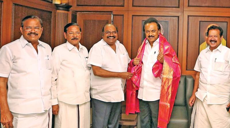 DMK party MLA J. Anbazhagan presenting shawl to party working president M. K. 	Stalin at party headoffice after the Madras high court ordered a CBI probe into the illegal gutka issue on Thursday (Photo: DC)