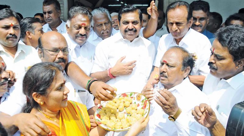 AIADMK cadres distribute sweets to Chief Minister Edappadi K. Palaniswami and Deputy CM O. Panneerselvam in Chennai on Thursday. 	(Photo: DC)