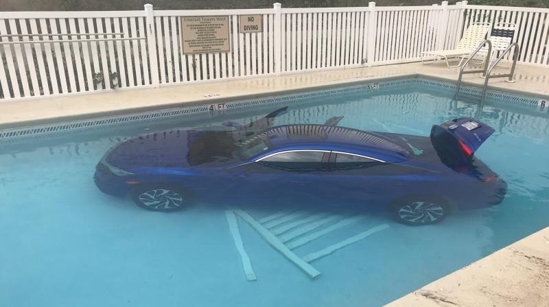 Car land in pool with father and child still inside. (Photo: Facebook /Okaloosa County Sheriffs Office)