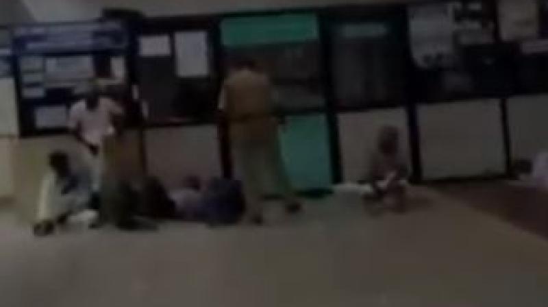 In a blatant misuse of power, Vijayakumar, the security guard, brutally hit the passengers with his cane and asked them to leave the terminal. (Photo: screengrab)