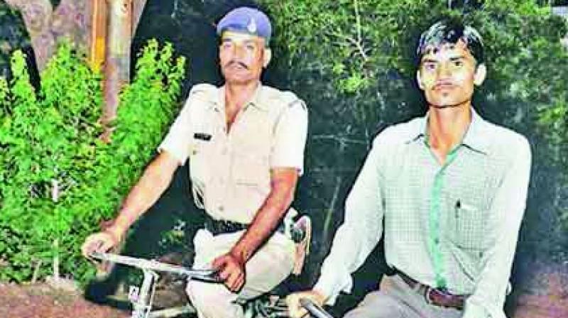 Ashish Chaturvedi with a police. (Photo: DC