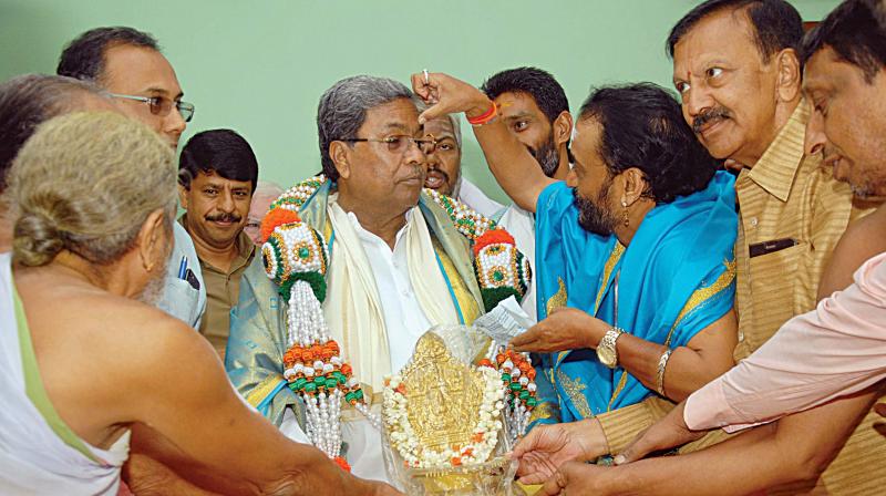 CM Siddaramaiah being greeted by Hindu priests at his home office, Krishna in Bengaluru on Wednesday