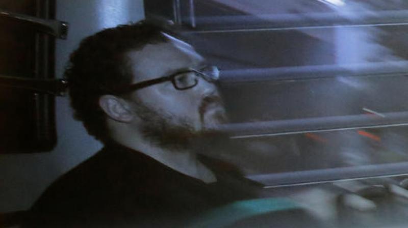 In this Nov. 24, 2014 file photo taken through a tinted glass, Rurik Jutting, a British banker, sitting in a prison bus arrives at a court in Hong Kong. (Photo: AP)