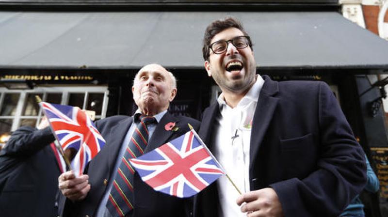 UK Independence Party (UKIP) leadership hopeful Raheem Kassam, right, poses for a photograph with former Royal Marine Dave Smith, 73, in Westminster, London. (Photo: AP)