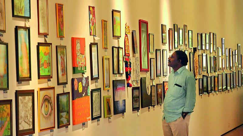 An art lover checking out the various paintings that are on display (Photo used for representational purpose)