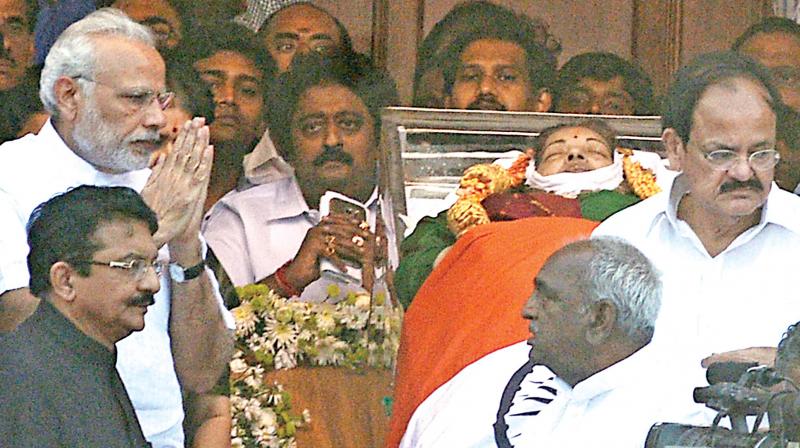 PM Modi pays homage to Jayalalithaa at Rajaji Hall. (inset) An AIADMK cadre grieves after visiting Jayas Poes Garden home thrown open to public after her demise.