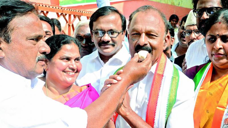 Vijayawada city Congress president V. Gurnatham offers sweets to PCC president N. Raghuveera Reddy and others, welcoming the statement of UPA chairperson Sonia Gandhi on giving special status to AP, at Andhra Ratna Bhavan in Vijayawada on Saturday.  (DECCAN CHRONICLE)