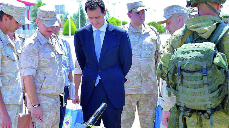 Syrian President Bashar  al-Assad inspects weapons during his visit to a Russian military base in Syria. (Photo: AFP)