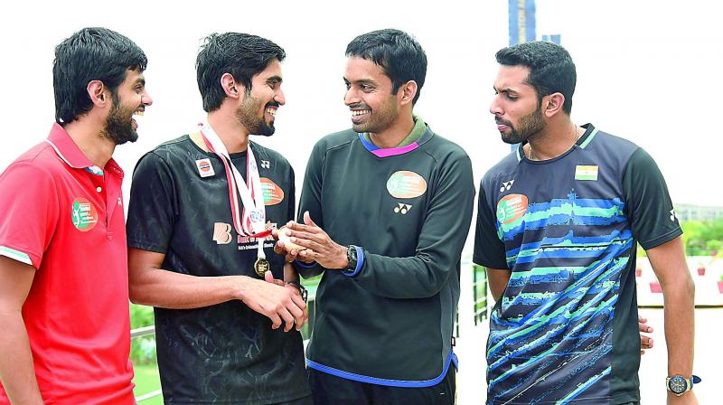 Srikanth Kidambi (center) shares a light moment with Sai Praneeth (left), Pullela Gopichand at the Gopichand Badminton Academy in Hyderabad on Tuesday. (Photo: R. PAVAN)
