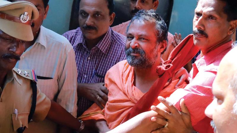 CBI officials bring Swami Raghavendra Thirtha, who was said to be missing for several years, to Kochi on Tuesday. (Photo: ARUN CHANDRABOSE)