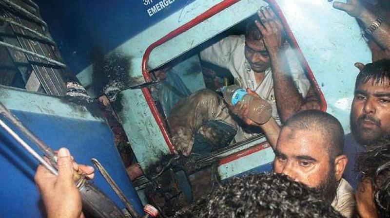 A passenger is rescued from one of the coaches of the Puri-Haridwar Utkal Express train after it derailed in Khatauli near Muzaffarnagar on Saturday (Photo: PTI)