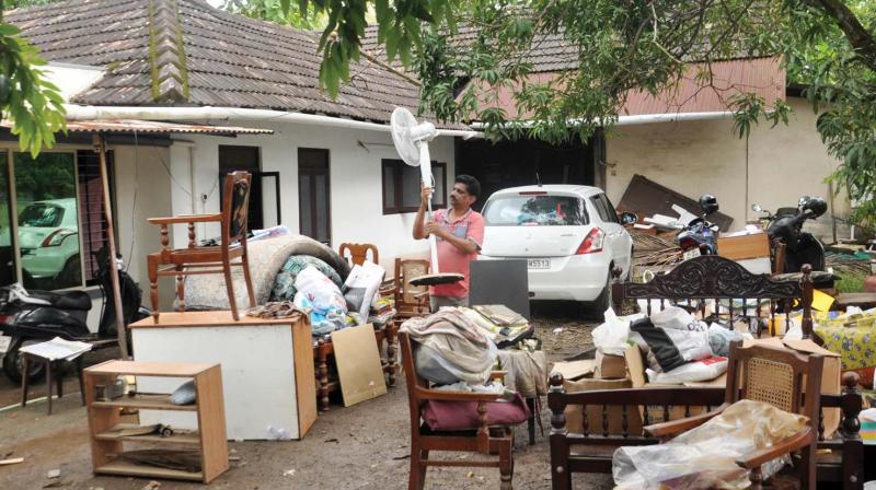 A house-owner keeping his households  in his courtyard during the cleaning operation at Chittoor near Kochi on Tuesday (Photo: SUNOJ NINAN MATHEW)