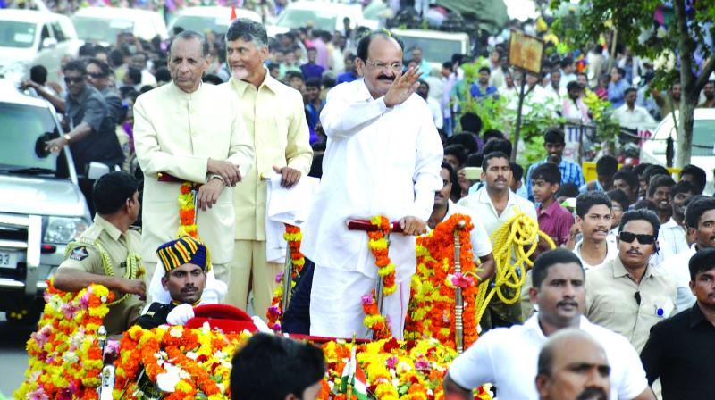 Vice-President M. Venkaiah Naidu waves at his public reception at Amaravati as Chief Minister N. Chandrababu Naidu and Governor E.S.L. Narasimhan look on.  (Photo:DC)