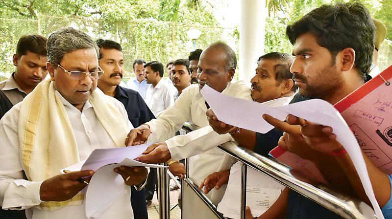 Chief Minister Siddaramaiah receives petitions during Janata Darshan programme in Bengaluru on Saturday	(Photo:DC)