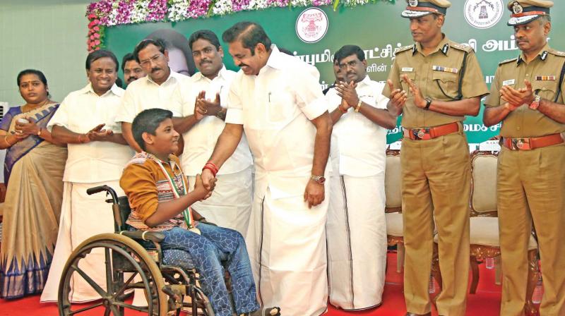 CM Palaniswami congratulates a winner after handing over a medal at the 9th south zone shooting competition held at Chennai Rifle Club, Avadi on Saturday.