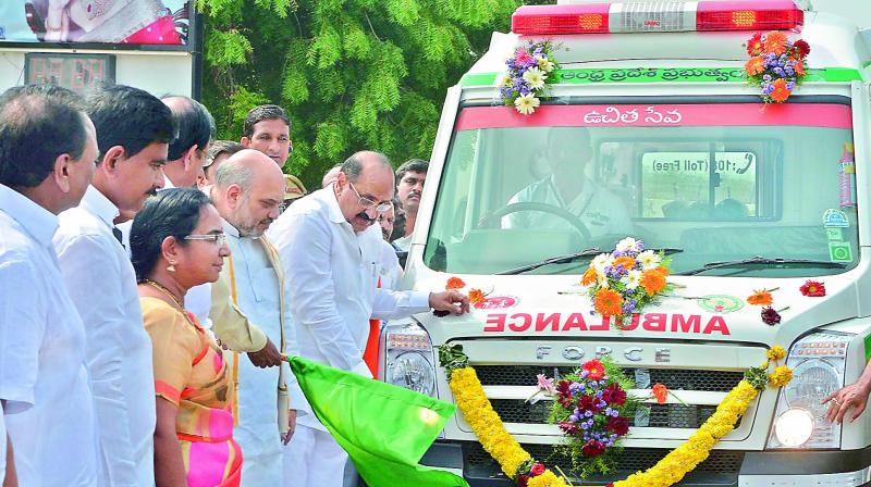 BJP national president Amit Shah flags off an advanced emergency ambulance at Vijayawada airport on Thursday. Health minister Kamineni Srinivas and MP Gokaraju Gangaraju are also seen. (Photo: DC)
