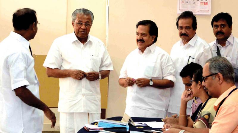 Chief Minister Pinarayi Vijayan and  opposition leader Ramesh Chennithala share a light moment during the election to Rajya Sabha at the polling booth arranged inside the Assembly on Friday. (Photo: PEETHAMBARAN PAYYERI)