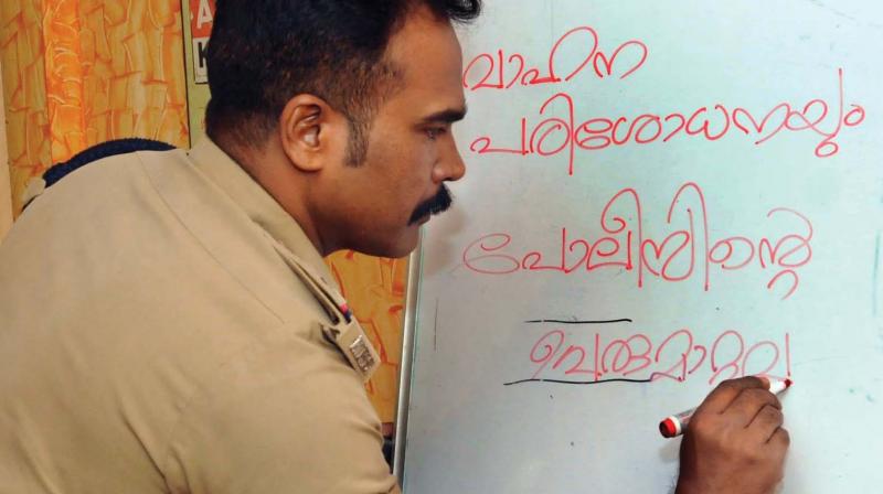 Central Station Head Officer A. Anantha Lal takes classes on Tuesday following SPC Loknath Beheras  circular to impart training to police personnel in good behavior.  (Photo: ARUN CHANDRABOSE)