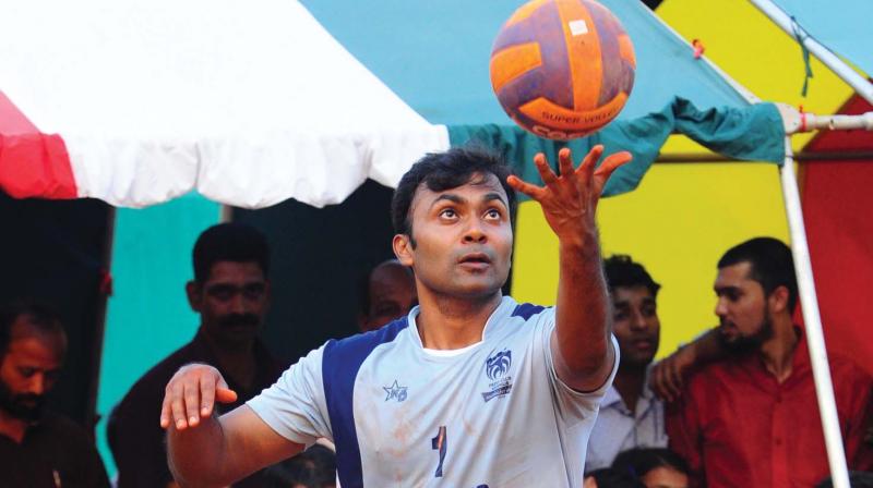 Kannur district police chief G. Siva Vikram gets ready to serve during a match in Infantry Ground, Kannur.  	 DC file photograph