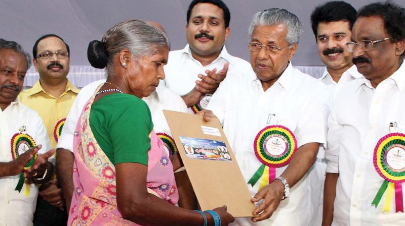 Chief Minister Pinarayi Vijayan presents documents connected with Forest Rights Act and title deeds to tribal community members of Kuttampuzha on Saturday. (Photo: DC)
