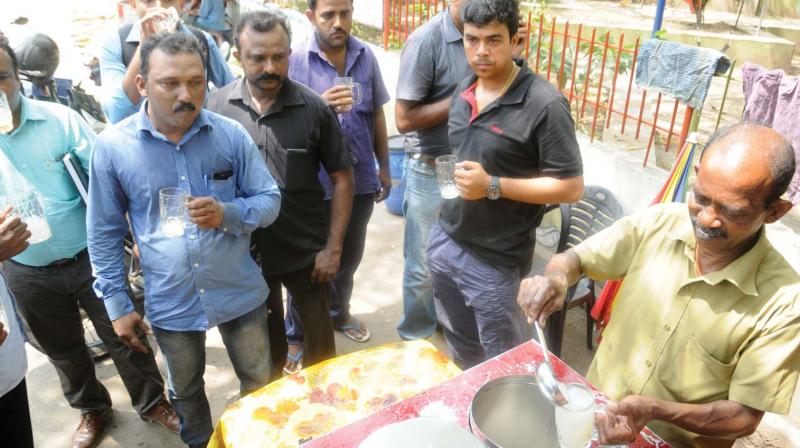 People queue up in front of a juice shop at Pipinmoodu near Sasthamangalam.