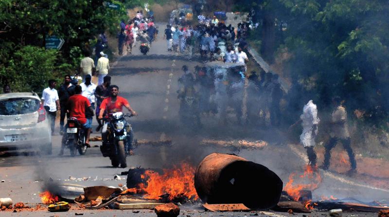Protesters burn tyres blocking NH-66 near VK Padi in AR Nagar on Friday.
