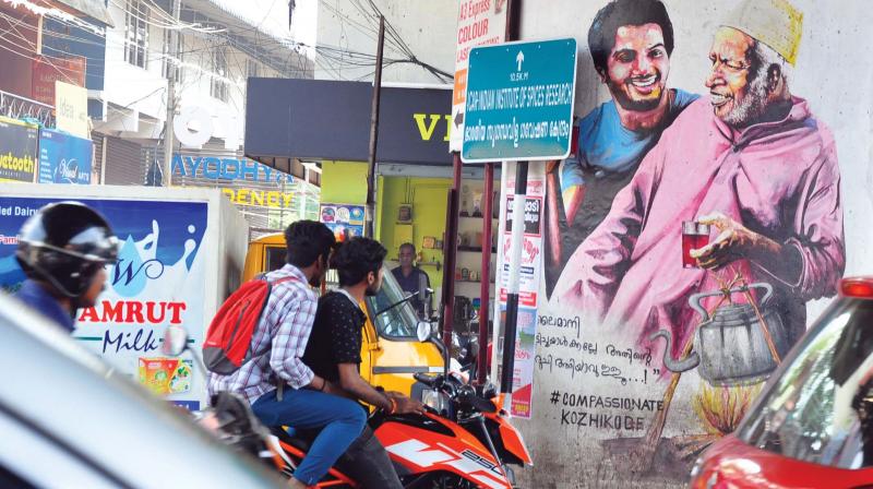 A view of the art pillar, defaced by flex boards, in Kozhikode city.