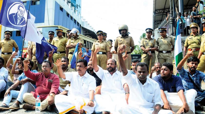 Former MLA U.C. Raman leads a sit-in protest as part of the statewide hartal called by dalit organisations on Monday. (Photo: VENUGOPAL)