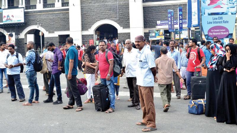 Commuters wait for transportation in front of the Thiruvananthapuram central railway station on Monday. 	(Photo: Peethambaran Payyeri)