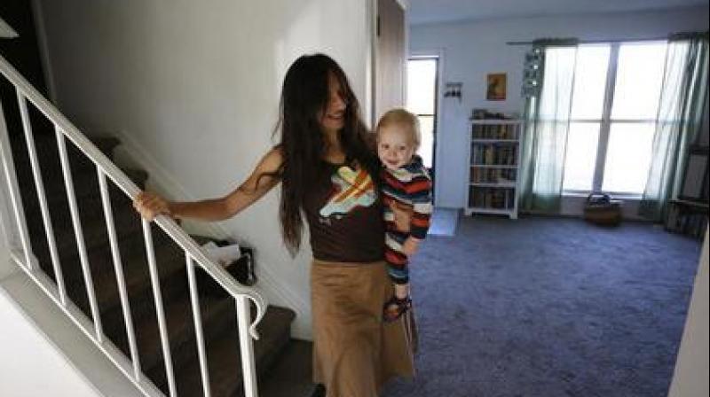Vegan mother Fulvia Serra carries her 1-year-old baby, Sebastiano, at home in Fort Collins, Colo. Serra. (Photo: AP)