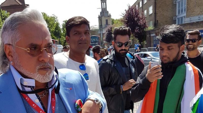 Vijay Mallya for a fleeting second looked back before showing his customary non-challance while making his way to the Hospitality Box to watch the India versus South Africa clash in the ICC Champions Trophy at The Oval. (Photo: ANI Twitter).