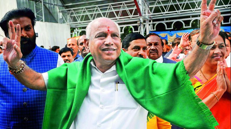 BJP leader B. S. Yeddyurappa flashes the victory sign as he arrives to take oath as Chief Minister of Karnataka, in Bengaluru, on Thursday. 	(Photo: PTI )