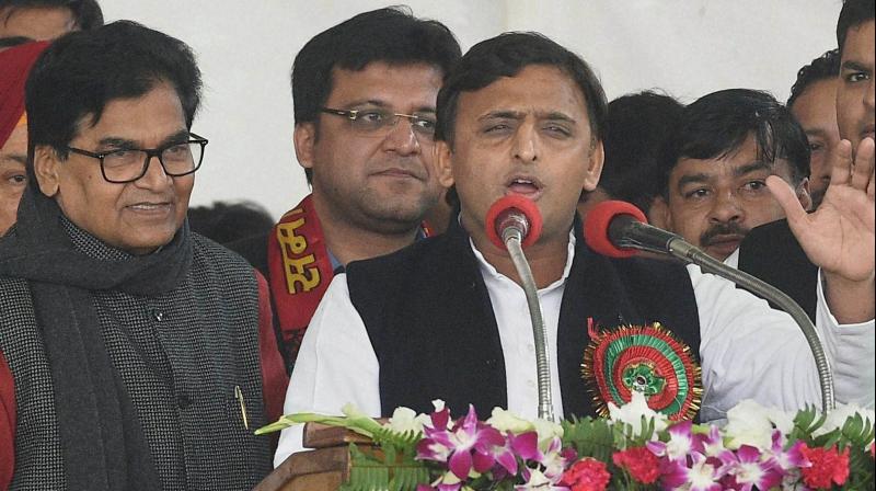 Uttar Pradesh Chief Minister and newly unanimously elected partys national president Akhilesh Yadav addresses as SP general secretary Ram Gopal Yadav looks on during Samajwadi party national convention in Lucknow on Sunday. (Photo: PTI)
