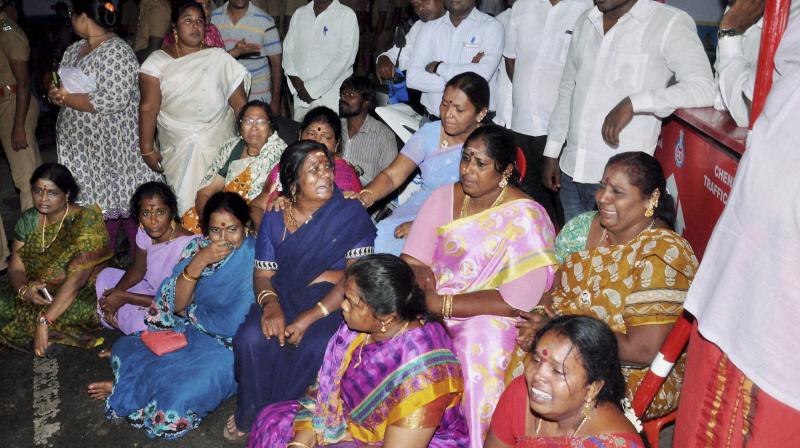 AIADMK supporters sit in front of Apollo Hospital after Tamil Nadu Chief Minister, Jayalalithaa suffered a cardiac arrest in Chennai. (Photo: PTI)