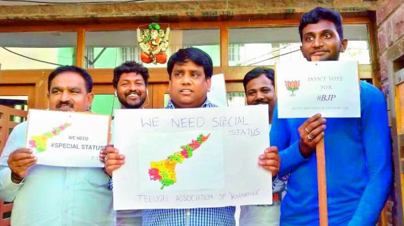 Telugu Association for Karnataka members hold placards calling on Telugus to vote against the BJP in the Karnataka Assembly elections.