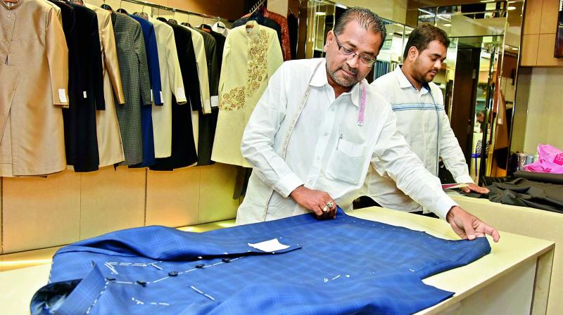 Tailors give final shape to a sherwani at a shop in the city on Thursday.  (Image: P.Surendra)
