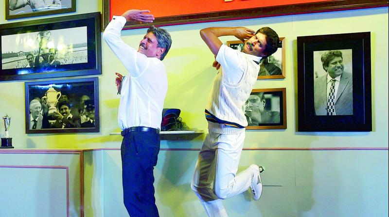 Former India cricket captain Kapil Dev strikes a pose in front of his Madame Tussauds wax figure at an event in New Delhi on Thursday. (Photo: AP)