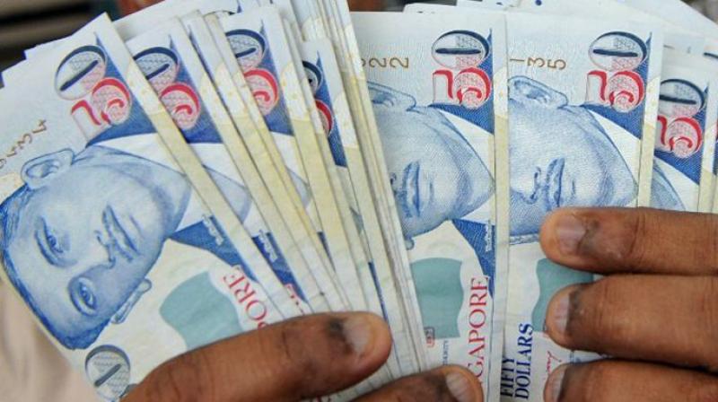 Sasi Kumar Lakshmanan decided to print fake currency notes of SG dollar 100 and SG dollar 50. (Photo: AFP)
